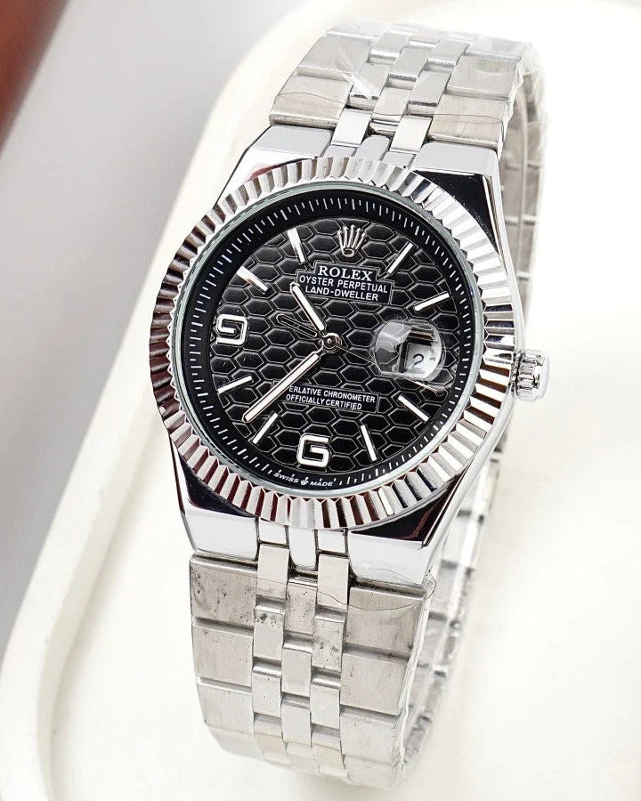 Rolex Land-Dweller Watch — Black Patterned Dial with Arabic Numerals and Fluted Bezel