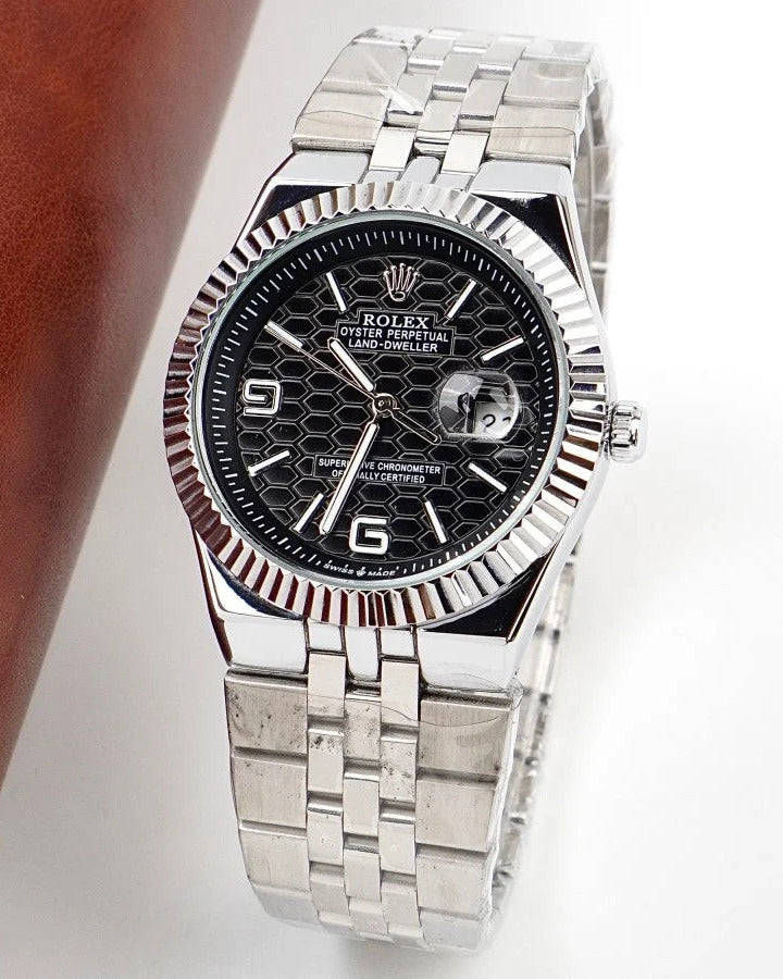 Rolex Land-Dweller Watch — Black Patterned Dial with Arabic Numerals and Fluted Bezel