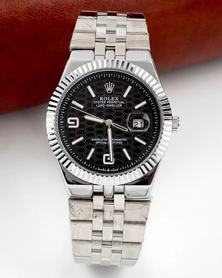 Rolex Land-Dweller Watch — Black Patterned Dial with Arabic Numerals and Fluted Bezel