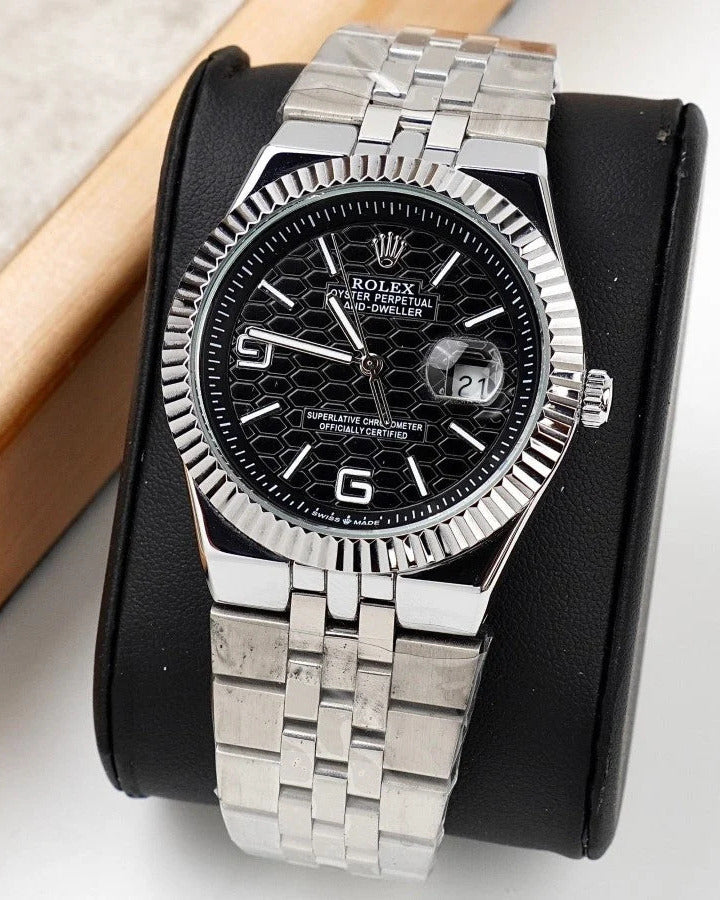 Rolex Land-Dweller Watch — Black Patterned Dial with Arabic Numerals and Fluted Bezel